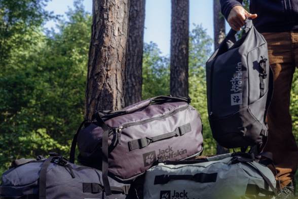 Duffles stacked on top of each other in the forest